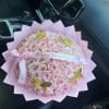 Pink rose bouquet with a birthday ribbon and gold butterfly decorations