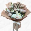 Bouquet of pale roses and white flowers wrapped in tan paper with a ribbon