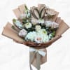 Bouquet of pale roses and white blooms wrapped in tan paper