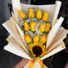 Bouquet of yellow roses and a sunflower wrapped in cream paper