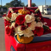 Bouquet of red and white flowers arranged in a pumpkin container
