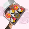 Box of decorated cupcakes with a Mother's Day topper