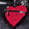 Heart-shaped bouquet of red roses wrapped in black paper with a black ribbon