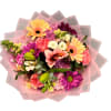 Mixed bouquet with pink, purple, and yellow flowers wrapped in pink paper