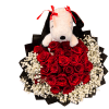Stuffed Snoopy sits atop a heart-shaped bouquet of red roses