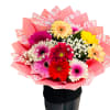 Colorful bouquet of gerbera daisies wrapped in pink paper