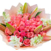 Bouquet of pink roses with white lilies and pale wrapping
