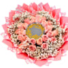 Bouquet of pink roses with baby's breath in pink wrapping