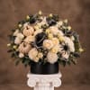 Cream rose arrangement with pumpkins and black spider decorations in a black box