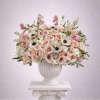 Blush and white rose arrangement in a white urn vase
