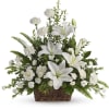 White lilies and carnations arranged in a brown wicker basket