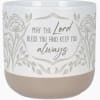 White candle jar with floral pattern and blessing text