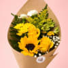 Yellow bouquet with roses, a sunflower, and white filler flowers in brown paper
