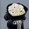 Bouquet in black stylish packaging, with white flowers