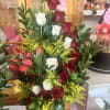 Tall bouquet of red and white roses with pink tulips in a black box