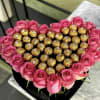 Heart-shaped box of pink roses filled with gold-wrapped chocolates