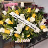 Yellow and white roses with lilies in a wooden box