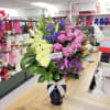 Mixed bouquet of pink and white roses with lilies in a blue vase
