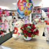 Red rose bouquet with a teddy bear and birthday balloon