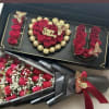 Gift box with red roses and chocolates, plus a bouquet of red roses wrapped in black paper