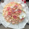 Pink rose bouquet with white orchids and a birthday topper