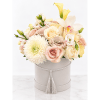 Pastel bouquet of roses, calla lilies, and chrysanthemums in a round hat box