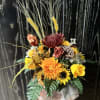 Autumn floral arrangement with yellow and orange blooms in a vase