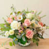 Pink and white rose bouquet in a clear glass vase