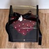 Black gift box with red rose design and a black ribbon bow