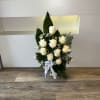 funeral base with white roses