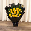 Bouquet of yellow roses with gold-wrapped chocolates in black paper
