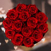 Round bouquet of red roses in a black container