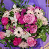 Pink and white mixed bouquet wrapped in purple paper