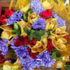 Bouquet of red roses, purple chrysanthemums, and yellow orchids
