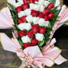 Bouquet of red and white roses wrapped in pink paper