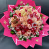 Round bouquet of red and peach roses wrapped in bright pink paper with gold butterfly accents.