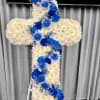 Standing cross of white flowers with cascading blue roses and blooms on an easel