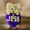 Standing white and purple floral arrangement shaped like a cartoon cat with the name Jess
