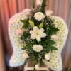 Standing white floral arrangement with chrysanthemum wings and central roses and lilies