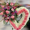 Standing heart-shaped sympathy wreath of white mums with pink roses and lilies.