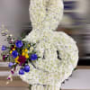 Standing white chrysanthemum ribbon arrangement with blue roses and mixed accent flowers.
