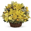 Basket arrangement of yellow lilies, roses, daisies, and mixed blooms with a small decorative butterfly accent