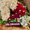 Heart-shaped arrangement of cream and red roses with chocolates and white orchids in an anniversary box