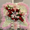 Standing angel-wing floral arrangement of white mums with pink feathers, roses, and a lily.