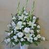 White lilies and daisies arranged in a white vase