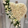 Heart-shaped bouquet of cream roses and white lilies