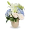 White lilies, blue hydrangeas, and cream roses in a beige vase