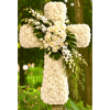 White floral cross with roses and hydrangeas outdoors