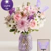 Pink and white mixed bouquet in a purple textured vase with a butterfly topper