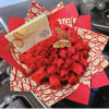 Bouquet of red roses wrapped in red and cream paper with butterfly accents